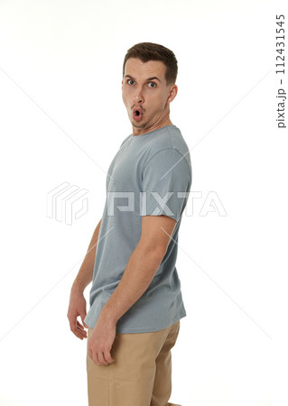 surprised guy looking at camera on white studio background 112431545