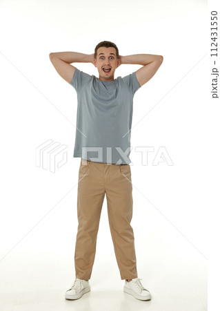 surprised guy looking at camera on white studio background 112431550