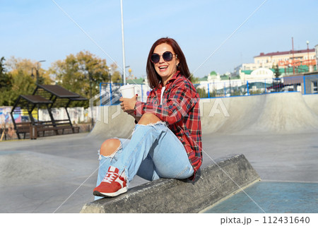 a confident young woman walks through the streets of the city, a woman smiles and enjoys life a confident young woman walks through the streets of the city, a woman smiles and enjoys life 112431640
