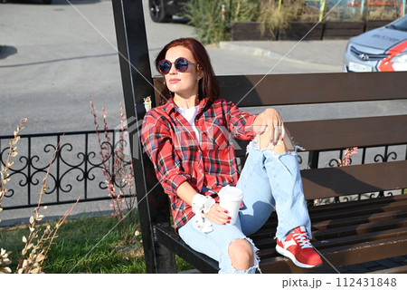 a confident young woman walks through the streets of the city, a woman smiles and enjoys life a confident young woman walks through the streets of the city, a woman smiles and enjoys life 112431848