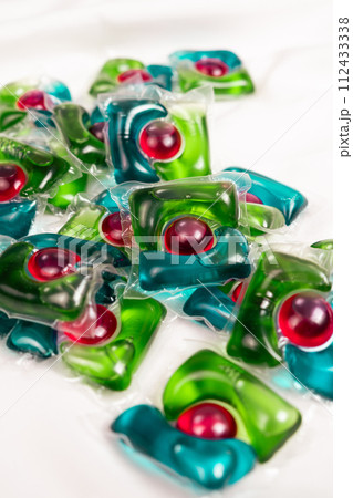 Lots of laundry pods on satin fabric close-up. Lots of laundry pods on satin fabric close-up. 112433338
