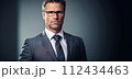 AI-generated content. Business man portrait. 40 year old business man wearing eyeglasses, looking at camera,, cinematic, banner. AI generated 112434463
