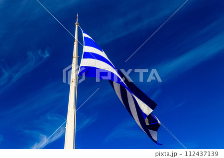 Flag of Greece on flagpole waving in the wind 112437139