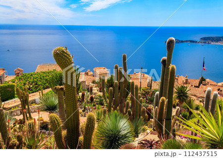 Scenic view of the Mediterranean coastline, medieval houses and exotic garden from the top of the medieval village of Eze village on the French Riviera 112437515