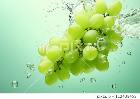 Green grapes in a splash of water and grape juice on a white background Green grapes in a splash of water and grape juice on a white background 112438458