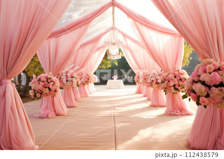 Wedding tent for a summer wedding celebration in nature, a festive pink covered tent decorated with flowers 112438579