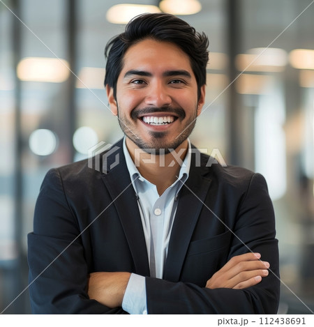 Portrait of a Hispanic male businessman 25-35 years in a suit against the background of an office 112438691