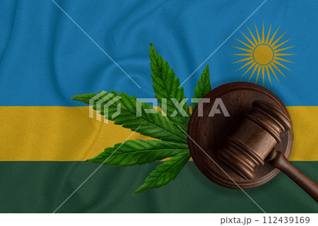 Gavel and the flag of Rwanda with the image of a cannabis leaf. The concept of legalization of marijuana in the country 112439169