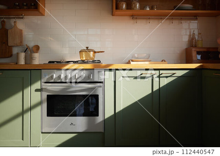 a sun-filled green kitchen a sun-filled green kitchen 112440547