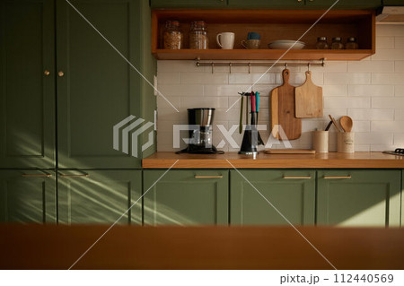 a sun-filled green kitchen a sun-filled green kitchen 112440569