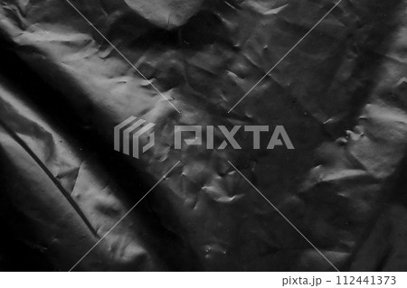 transparent plastic bag wrap overlay texture on black background 112441373
