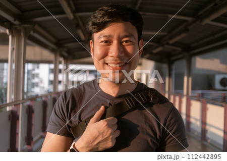 Happy ordinary man walk on the sky-train platform in Bangkok. Happy ordinary man walk on the sky-train platform in Bangkok. 112442895