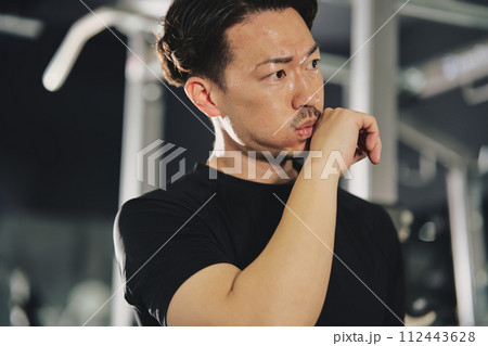 トレーニングジムで真剣な表情の男性 112443628