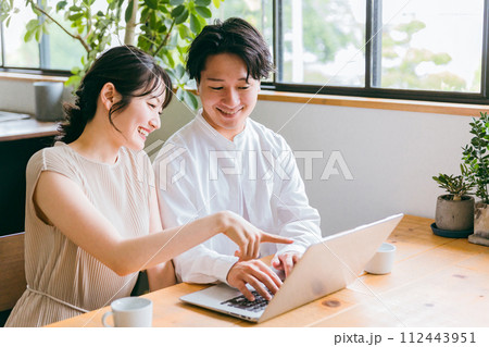 家でノートパソコンを見ながら話す夫婦・カップル(動画・相談・資産運用・ネットショッピング) 家でノートパソコンを見ながら話す夫婦・カップル(動画・相談・資産運用・ネットショッピング) 112443951