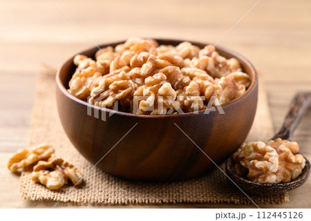 Organic raw walnuts in wooden bowl, Food ingredient Organic raw walnuts in wooden bowl, Food ingredient 112445126