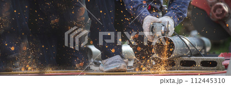 Banner Men hands wear protective glove Hot flame metal work cut fire iron workshop. Locksmith cut metal process. Construction Worker hands using Welding machinery iron metal sparking with copy space 112445310