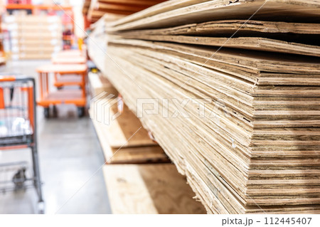 Selective focus on edge of stacked plywood in a retail store. Selective focus on edge of stacked plywood in a retail store. 112445407