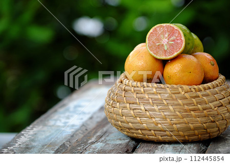 Isolated pink lemon fruit cut in half on green background Isolated pink lemon fruit cut in half on green background 112445854