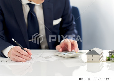 不動産の間取りを計算するビジネスマン 112448361