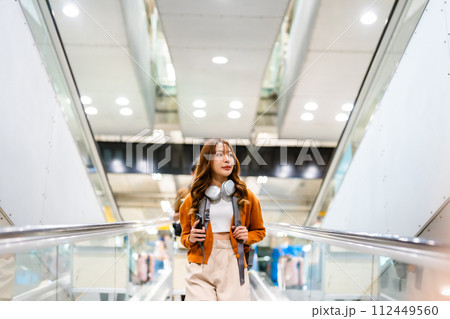 Young asian woman in international airport terminal or modern train station 112449560