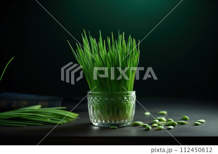 Celebrating renewal with sprouted wheat grass: happy nowruz, a festive homage to nature's rebirth, cultural traditions, and the joyous spirit of persian new year, embracing health and vitality. 112450612