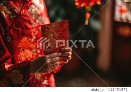 Chinese new year celebration, Cropped shot of hand receiving red envelopes from their parent 112451472