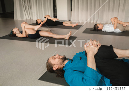 Children do yoga in the gym under the guidance of an instructor. Children's gymnastics 112451585