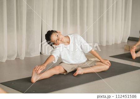 A child does yoga in the gym. Children's gymnastics 112451586