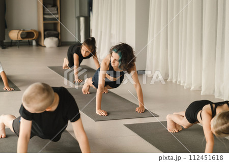 Children do Yoga in the fitness room. Children's gymnastics 112451618