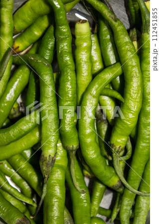 Fresh green chillies with selective focus Fresh green chillies with selective focus 112451855