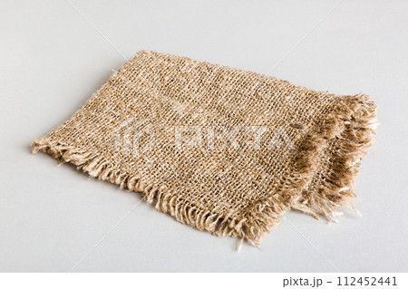 Old burlap fabric napkin, sackcloth on table background. top view with copy space 112452441