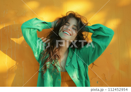 A woman in a green jacket is smiling and posing for a picture 112452954