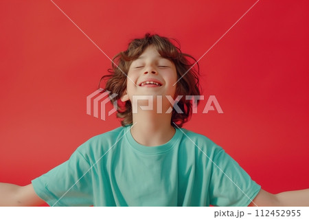 A young boy is smiling and wearing a green shirt 112452955