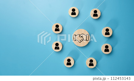 Team management concept, Human resources, Recruitment concept, HRM administration or human resource management concept, The handshake icon in a circular wooden board placed on a light blue background. Team management concept, Human resources, Recruitment concept, HRM administration or human resource management concept, The handshake icon in a circular wooden board placed on a light blue background. 112453143
