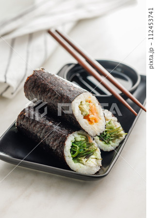 Sushi rolls on Plate with bowl of soy sauce and chopsticks. 112453741