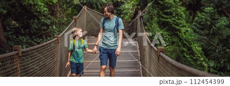 father and son tourists in Rope bridge in Yildiz Park. Besiktas, Istanbul, Turkey. Turkiye. Traveling with kids concept BANNER, LONG FORMAT 112454399