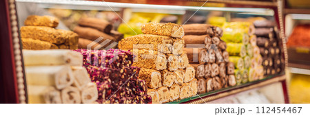 BANNER, LONG FORMAT Traditional oriental sweet pastry cookies, nuts, dried fruits, pastilles, marmalade, Turkish desert with sugar, honey and pistachio, in display at a street food market BANNER, LONG FORMAT Traditional oriental sweet pastry cookies, nuts, dried fruits, pastilles, marmalade, Turkish desert with sugar, honey and pistachio, in display at a street food market 112454467