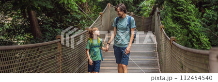 father and son tourists in Rope bridge in Yildiz Park. Besiktas, Istanbul, Turkey. Turkiye. Traveling with kids concept BANNER, LONG FORMAT father and son tourists in Rope bridge in Yildiz Park. Besiktas, Istanbul, Turkey. Turkiye. Traveling with kids concept BANNER, LONG FORMAT 112454540