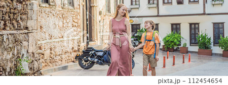 BANNER, LONG FORMAT Mom and son tourists in Old town Kaleici in Antalya. Turkiye. Panoramic view of Antalya Old Town port, Taurus mountains and Mediterrranean Sea, Turkey. Traveling with kids concept BANNER, LONG FORMAT Mom and son tourists in Old town Kaleici in Antalya. Turkiye. Panoramic view of Antalya Old Town port, Taurus mountains and Mediterrranean Sea, Turkey. Traveling with kids concept 112454654