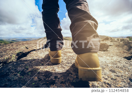 Hiking legs on high altitude mountain top 112454858