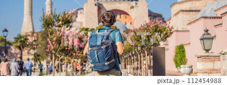 BANNER, LONG FORMAT Man enjoy beautiful view on Hagia Sophia Cathedral, famous islamic Landmark mosque, Travel to Istanbul, Turkey. Sunny day architecture and Hagia Sophia Museum, in Eminonu, istanbul 112454988