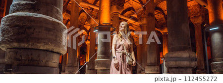 Woman tourist enjoying Beautiful cistern in Istanbul. Cistern - underground water reservoir build in 6th century, Istanbul, Turkey, Turkiye BANNER, LONG FORMAT 112455272