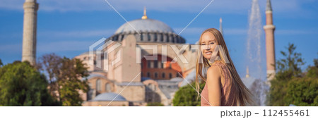 BANNER, LONG FORMAT Woman enjoy beautiful view on Hagia Sophia Cathedral, famous islamic Landmark mosque, Travel to Istanbul, Turkey. Sunny day architecture and Hagia Sophia Museum, in Eminonu BANNER, LONG FORMAT Woman enjoy beautiful view on Hagia Sophia Cathedral, famous islamic Landmark mosque, Travel to Istanbul, Turkey. Sunny day architecture and Hagia Sophia Museum, in Eminonu 112455461