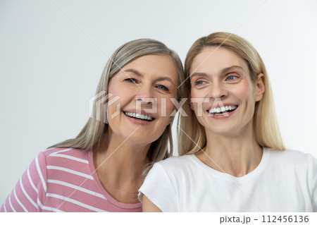 Mother and daughter having good time together and looking happy 112456136