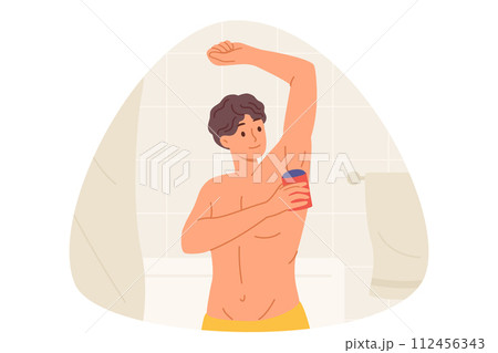 Man uses roll-on deodorant to get rid of sweat on armpits, standing in bathroom with torso naked Man uses roll-on deodorant to get rid of sweat on armpits, standing in bathroom with torso naked 112456343