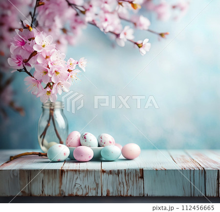 Easter light blue background anchors a delicate border of soft pink cherry blossoms and pastel Easter eggs Easter light blue background anchors a delicate border of soft pink cherry blossoms and pastel Easter eggs 112456665