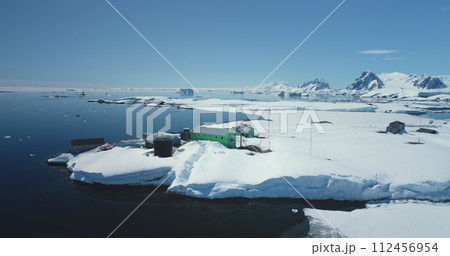 Ukrainian Antarctic research station Vernadsky among wild winter landscape. Expeditions, scientific research and explore on South Pole. Breathtaking harmony of untouched nature. Aerial drone panorama Ukrainian Antarctic research station Vernadsky among wild winter landscape. Expeditions, scientific research and explore on South Pole. Breathtaking harmony of untouched nature. Aerial drone panorama 112456954