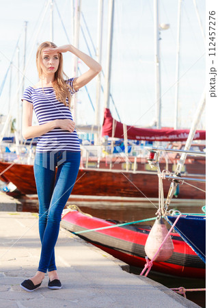 woman in marina against yachts in port woman in marina against yachts in port 112457276