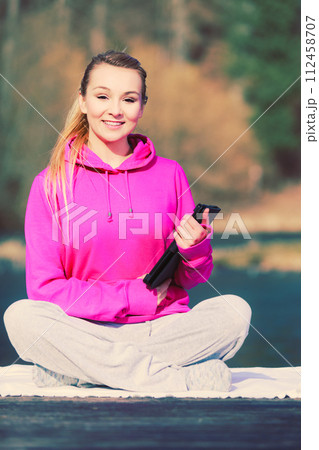 Girl learning yoga from tablet. 112458707