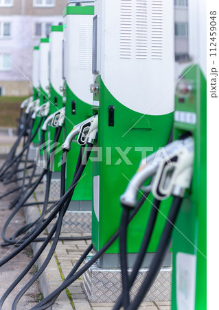 Car parking with charging stations near a multi-storey apartment building. Car parking with charging stations near a multi-storey apartment building. 112459048
